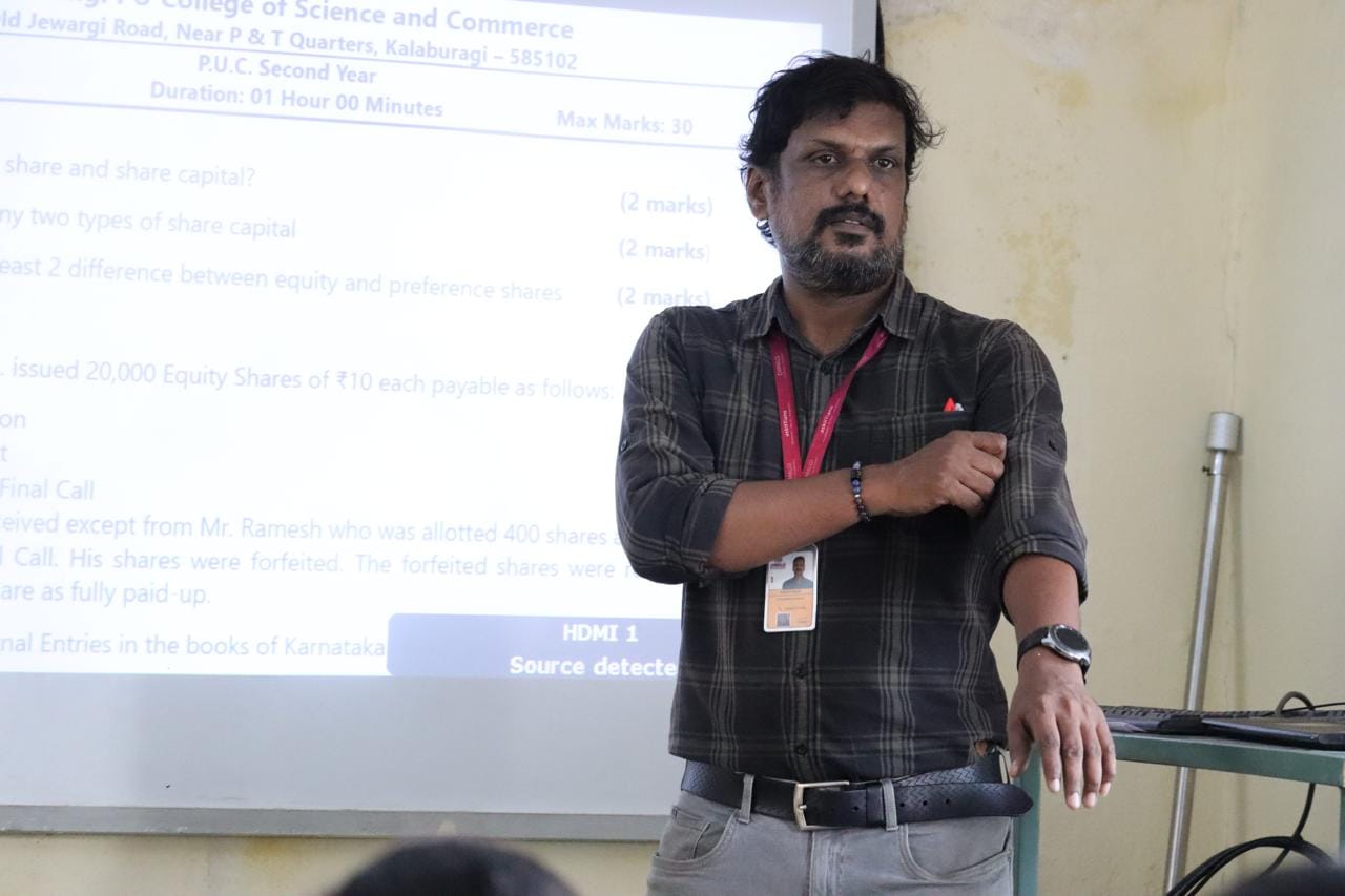 Faculty member teaching commerce students at Chimalgi PU College